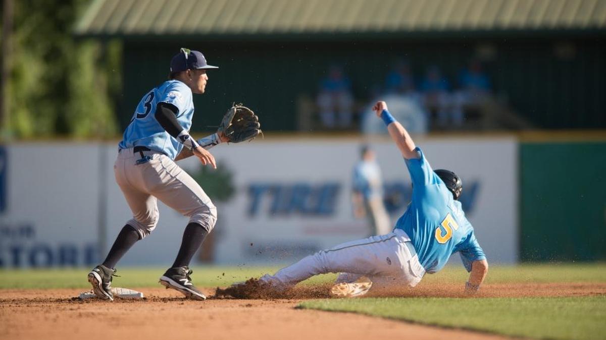 Myrtle Beach’s Ian Happ slides safely into second base as Wilmington’s Humberto Arteaga awaits a throw.