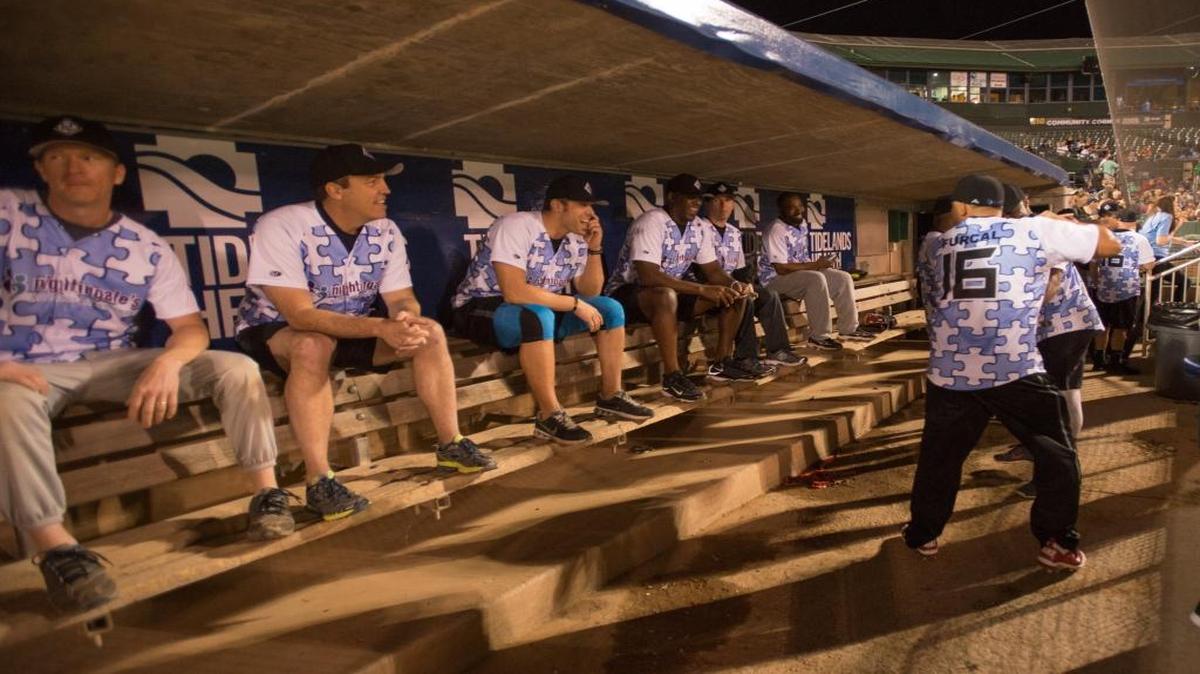 Rafael Furcal jokes in the dugout with the rest of his team before the start of the Legends Never Fade celebrity softball game.