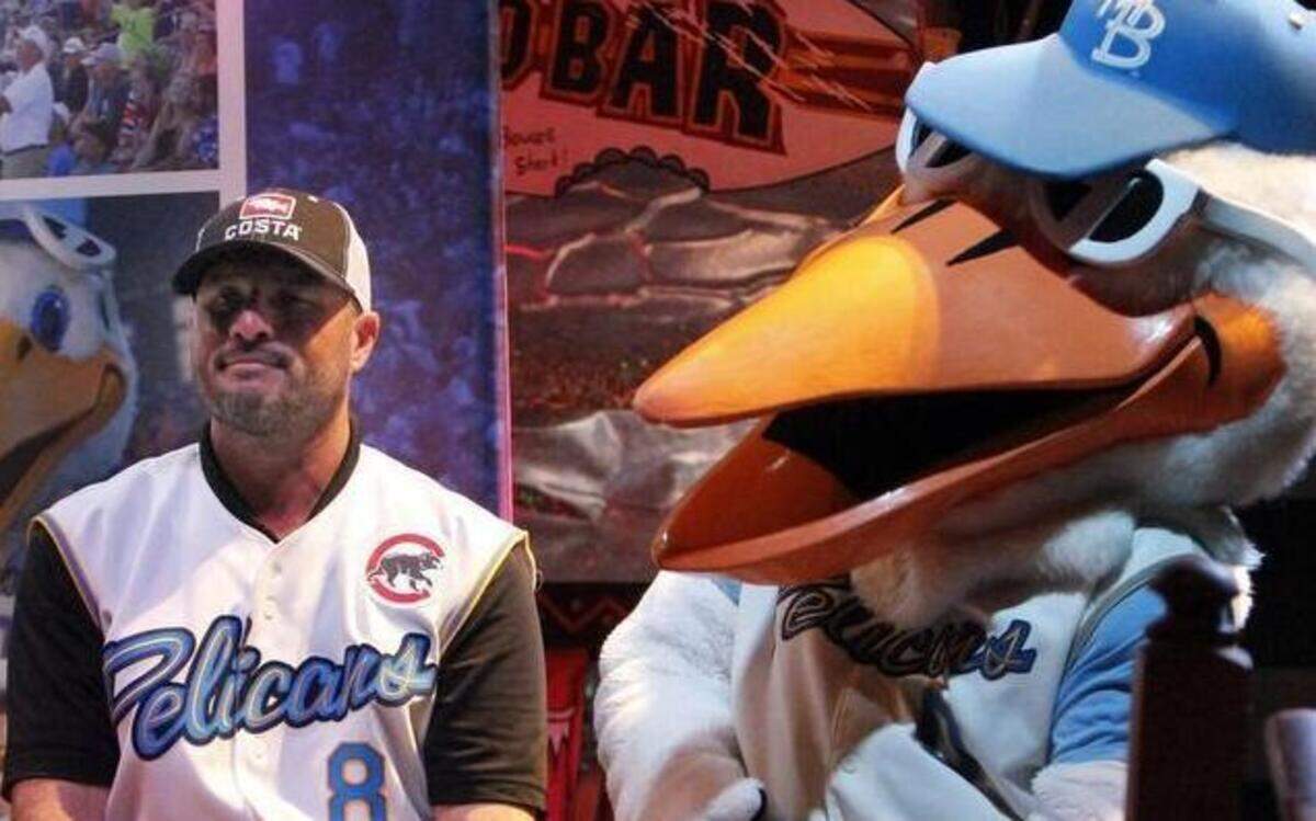 
Pelicans manager Mark Johnson sits beside Splash at the meet-and-greet for fans at Broadway Louie’s at Broadway at the Beach.

