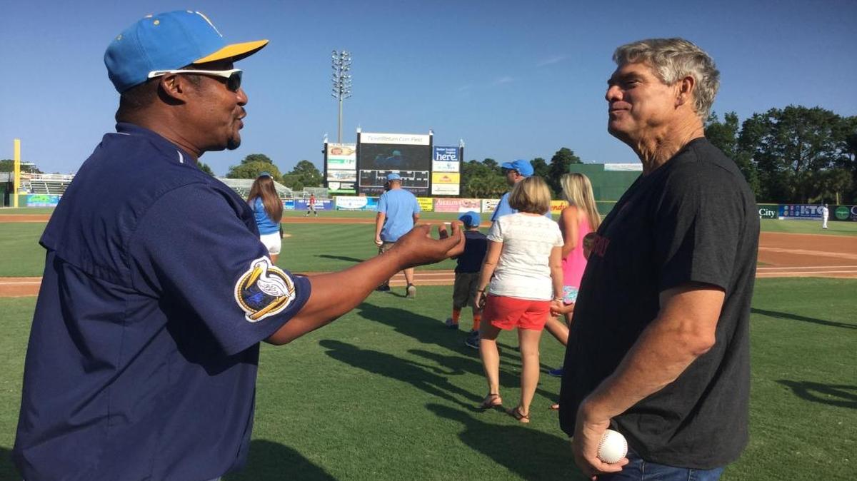 Former major leaguers Dale Murphy (right), in town to make a promotional speech ahead of the Myrtle Beach Pelicans’ game against the Carolina Mudcats on Sunday, and Mariano Duncan, the Pelicans’ hitting coach, embrace Murphy threw out the ceremonial first pitch.