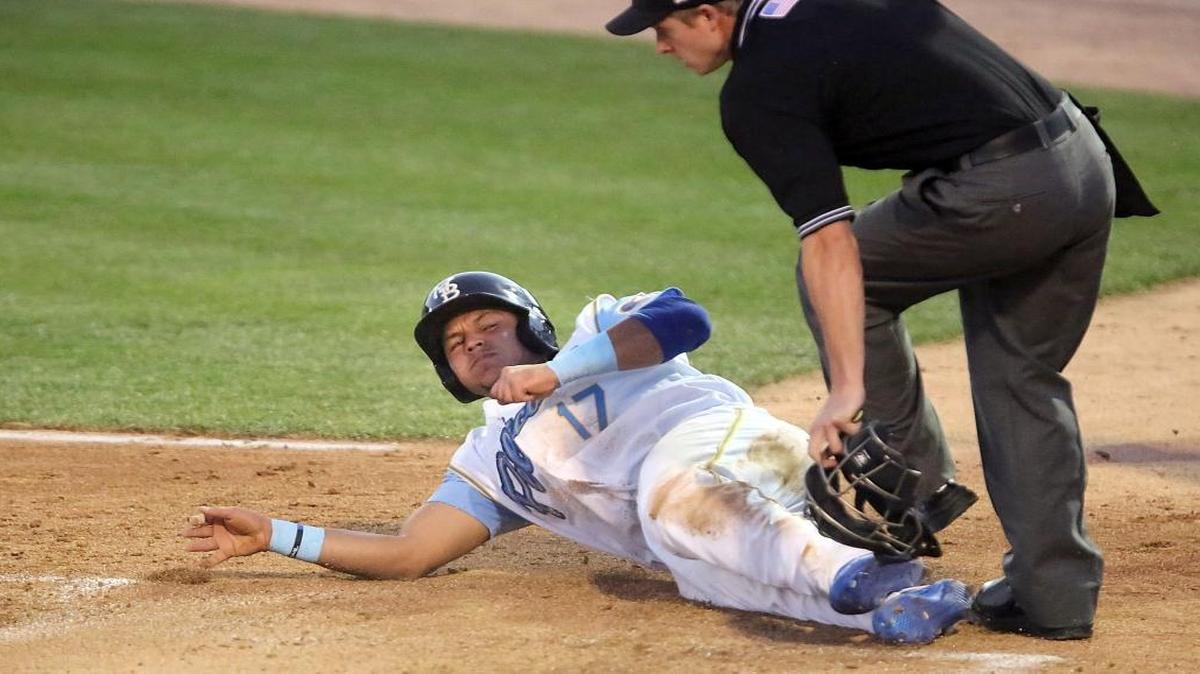 Gioskar Amaya slides into the umpire as the Pelicans open the season against the Frederick Keys on Thursday.