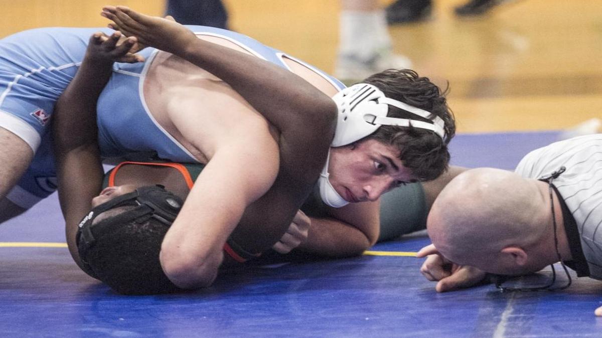 St. James’ Spencer Deegan looks for a call from the referee as he pins Timberland’s David William during the Battle at the Beach a couple weeks ago.