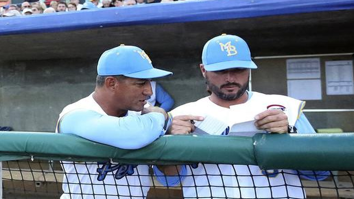 Pitching coach David Rosario talks with manager Mark Johnson before the Myrtle Beach Pelicans played against the Wilmington Blue Rocks.