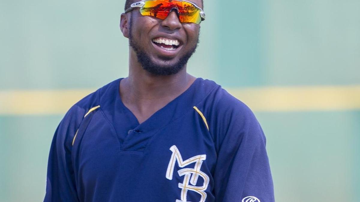 Former Myrtle Beach Pelicans outfielder Shawon Dunston Jr. jokes with team mates as he warms up for a game on Tuesday.