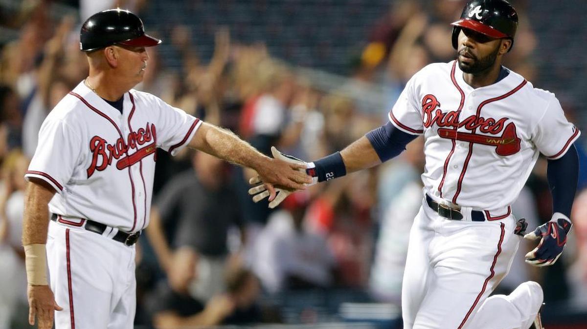 In this Aug. 14, 2013, file photo, Braves right fielder Jason Heyward, right, is greeted by then-third base coach Brian Snitker.