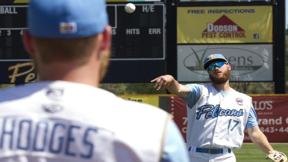 Myrtle Beach Pelican Matt Rose throws with third baseman Jesse Hodges during a practice session earlier this season.