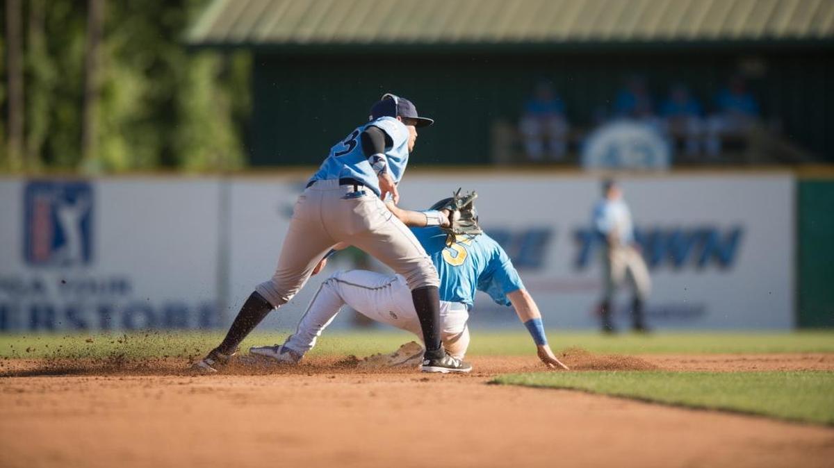 Myrtle Beach’s Ian Happ slides safely into second base as Wilmington’s Humberto Arteaga applies a late tag.