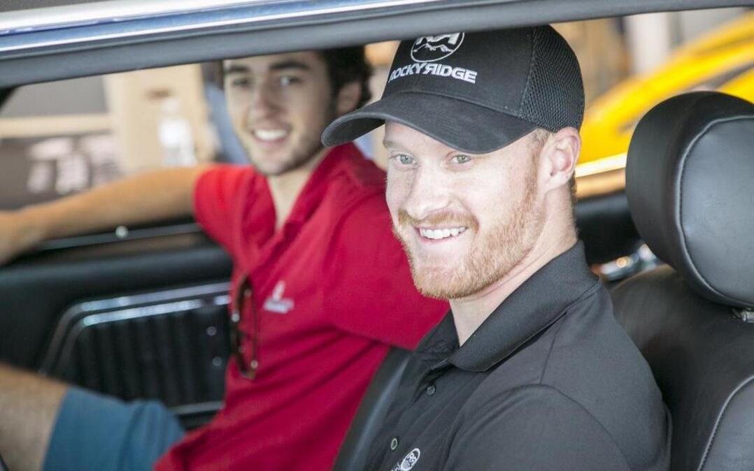 
Chase Elliott (left) and Jeb Burton sit in one of the classic cars on display at Jud Kuhn Chevrolet during a visit Thursday.
