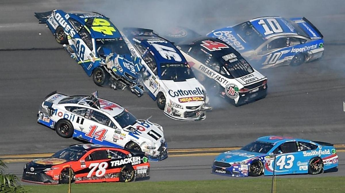 Jimmie Johnson (48), Clint Bowyer (14), Chris Buescher (37), Kevin Harvick (4) and Danica Patrick (10) collide in a multi-car wreck between Turns 3 and 4, as Martin Truex Jr. (78) and Aric Almirola (43) drive past during the Daytona 500 on Sunday.