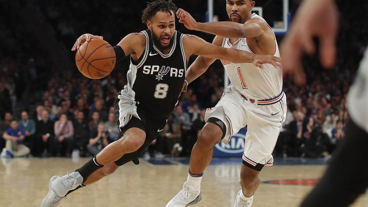 San Antonio Spurs guard Patty Mills (8) drives against New York Knicks guard Ramon Sessions (1) during the fourth quarter of a game on Jan. 2.
