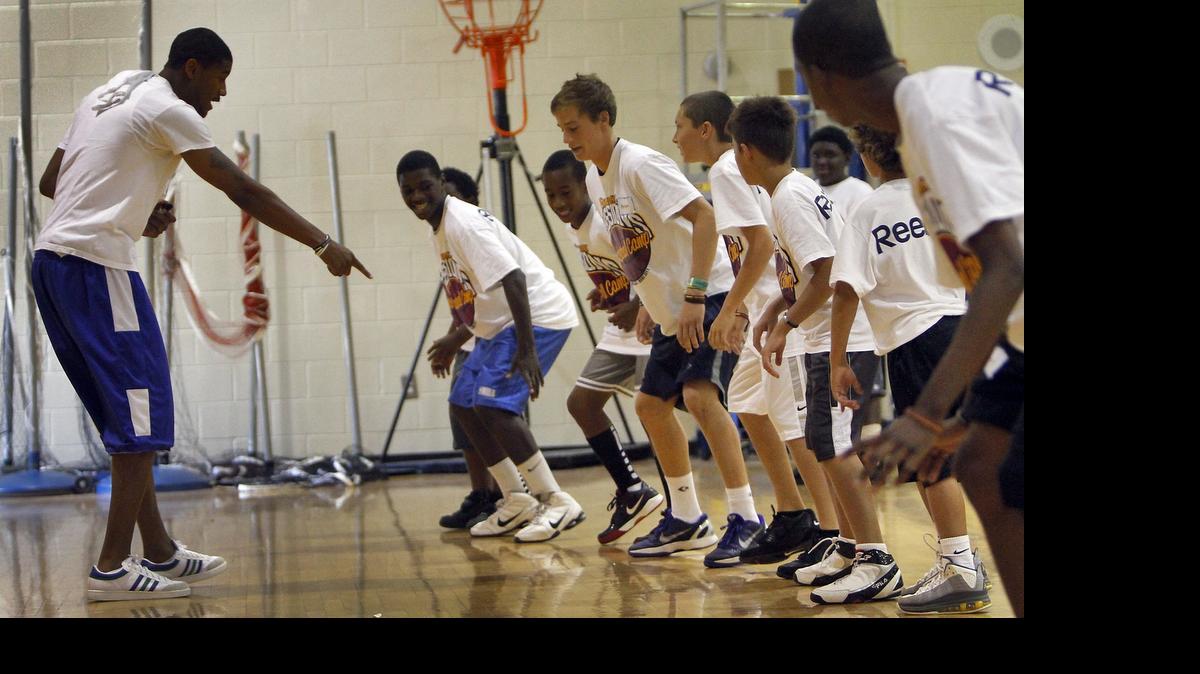 
Myrtle Beach native Trello Galloway (left) dictates a drill for kids at Ramon Sessions’ annual basketball camp in 2011.
