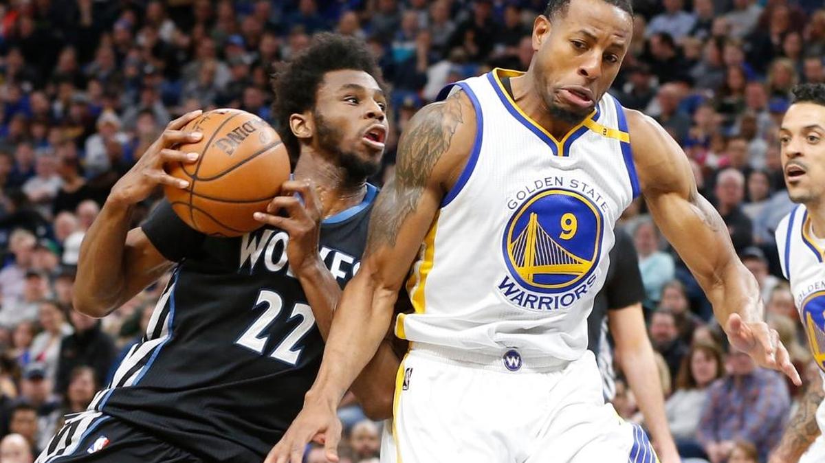 Minnesota’s Andrew Wiggins, left, bumps into Golden State’s Andre Iguodala during Friday’s game.
