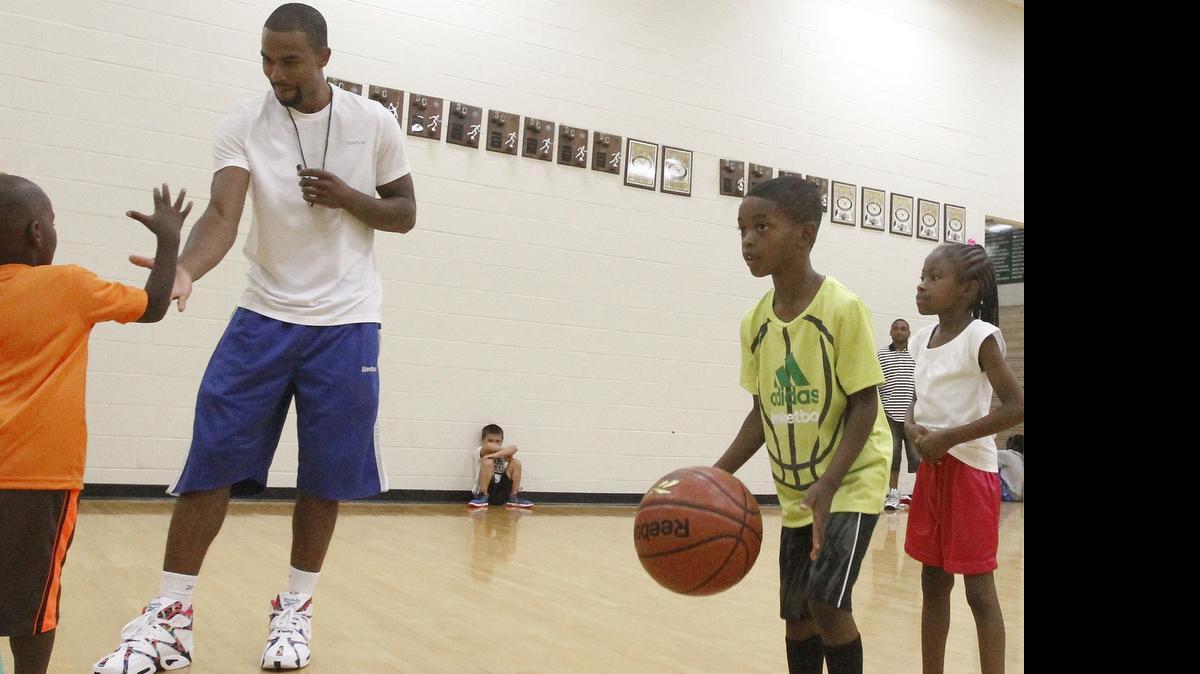 
Eight-year NBA veteran Ramon Sessions works with kids during his annual youth basketball camp Monday at his alma mater, Myrtle Beach High School.

