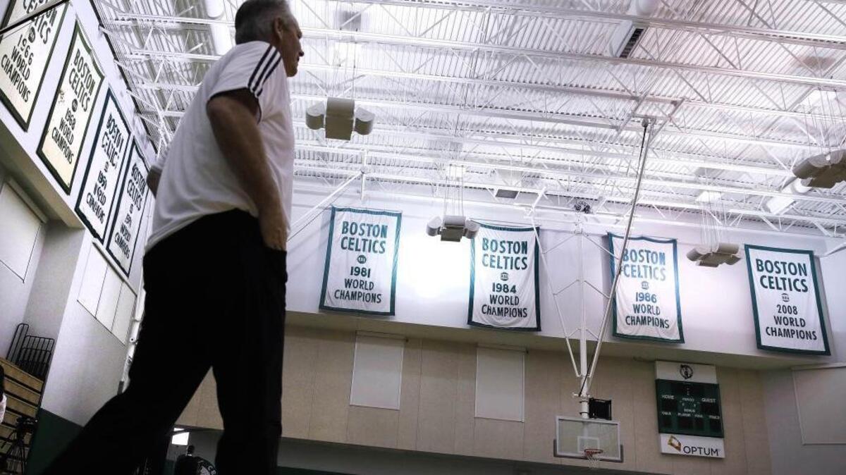 Danny Ainge, Boston Celtics president of basketball operations, walks past the team’s NBA championship banners at the team’s training facility in Waltham, Mass., earlier this month.