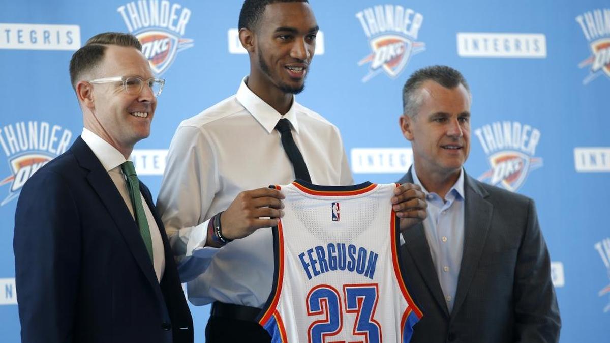 Oklahoma City Thunder general manager Sam Presti, left, and head coach Billy Donovan, right, introduce draft pick Terrance Ferguson during an press conference Saturday.