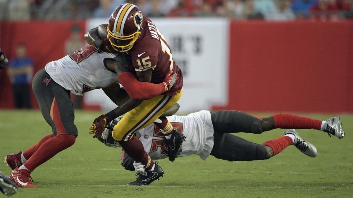 Wide receiver Matt Hazel is tackled by Tampa Bay’s Robert McClain, left, and Ryan Smith, right, during a preseason game while playing as a member of the Washington Redskins, who later released him. Hazel was claimed off waivers by the Indianapolis Colts but waived nearly two weeks later.
