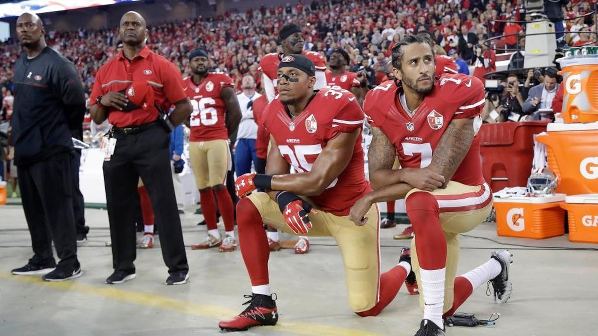 Former San Francisco 49ers quarterback Colin Kaepernick (7) kneels along side teammate Eric Reed during the national anthem before a game last September.
