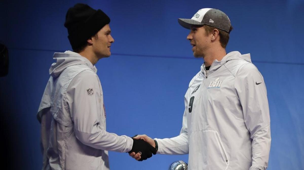 Philadelphia Eagles quarterback Nick Foles, right, shakes hands with New England Patriots quarterback Tom Brady on Monday.