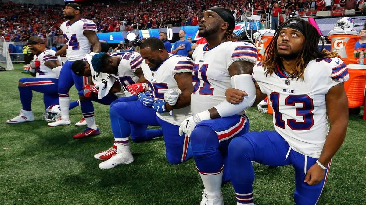 Buffalo Bills players take a knee during the national anthem before Sunday’s game against the Atlanta Falcons.