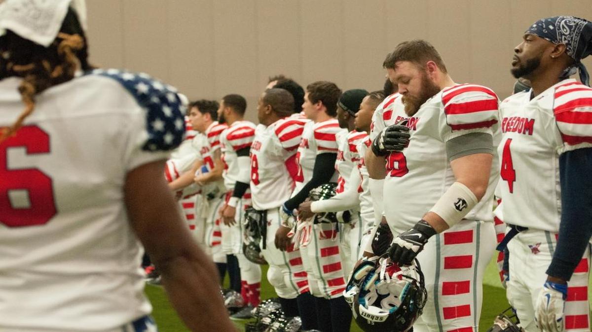 Players of the Myrtle Beach Freedom Stand for the national anthem before their game against the Carolina Dynasty.