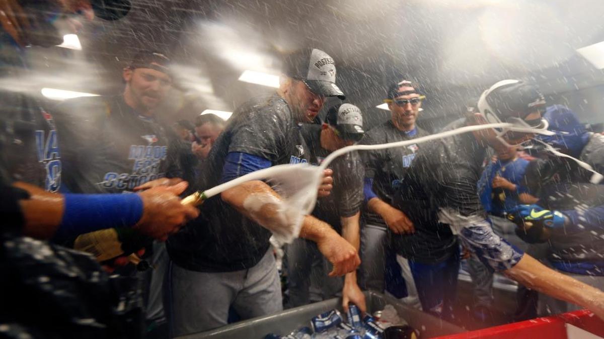 The Toronto Blue Jays celebrate after clinching a wild card playoff spot by defeating the Boston Red Sox 2-1 on Sunday.