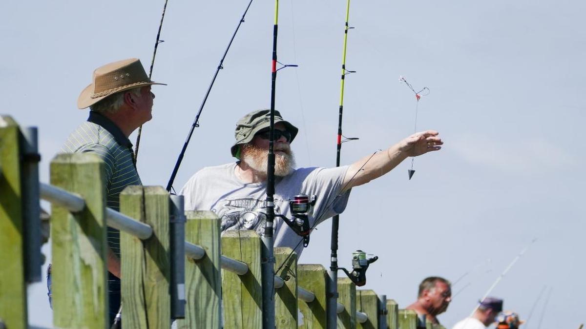 Fishermen line the public fishing dock at Cherry Grove Park at 53rd Avenue North in North Myrtle Beach.