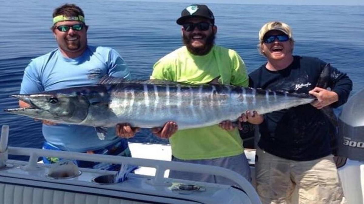 Austin Keener, Andrew Mattioli and Paul Pancake, all present or past members of Coastal Carolina University’s Saltwater Angler Club, show off a wahoo caught on a recent fishing trip.