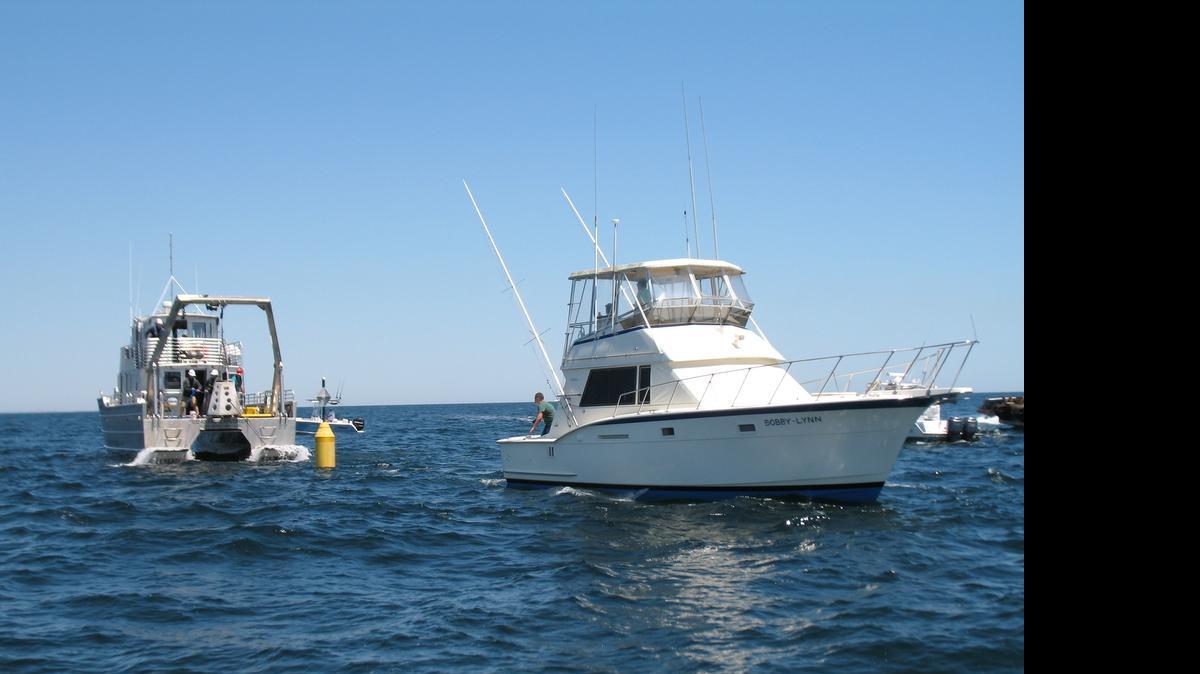 
Crew members aboard Bobby Lynn look on as the Ron McManus Memorial Reef is established off Little River on April 22.
