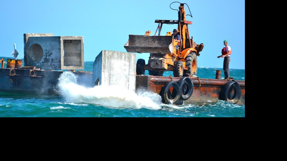 
Fourteen concrete boxes were dropped to the bottom as the latest addition to Paradise Reef, located three miles east of the Murrells Inlet jetties, on Monday.
