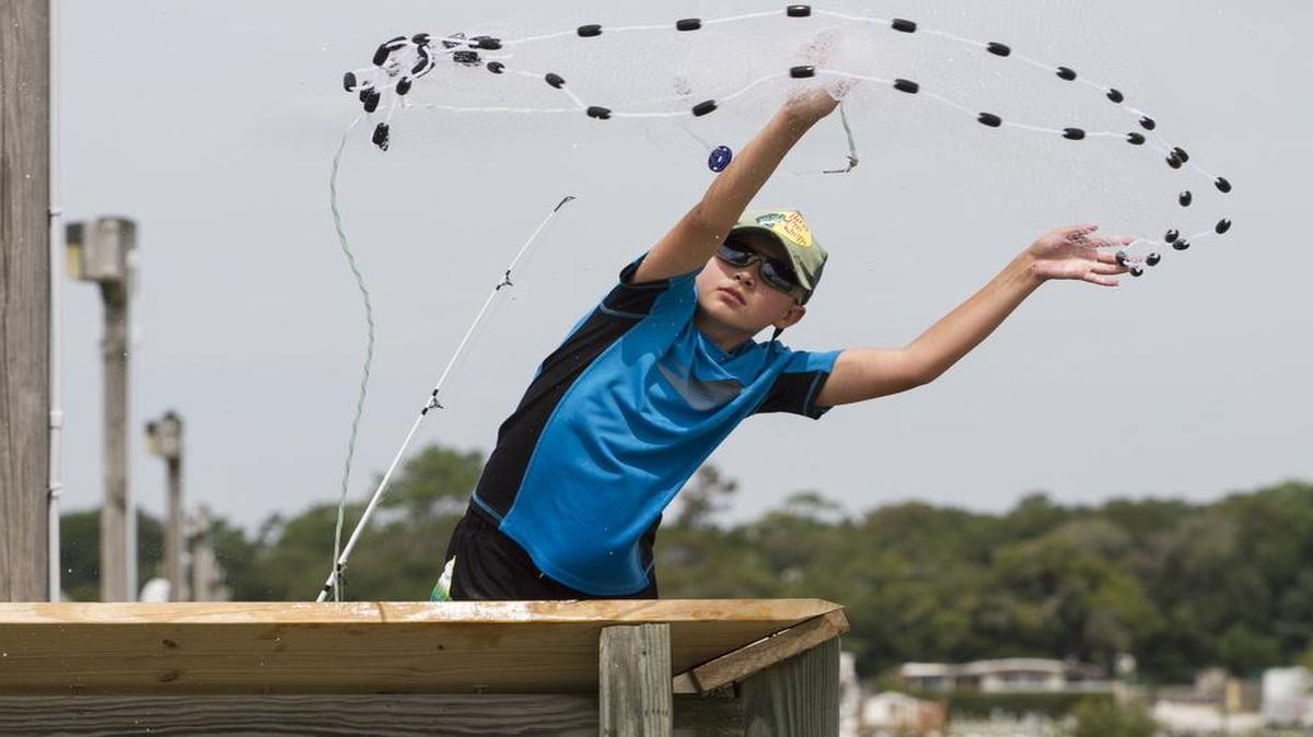 Dylan Garrity, of Berlin, N.J., throws a cast net from the Apache pier in hopes of catching bait last year.
