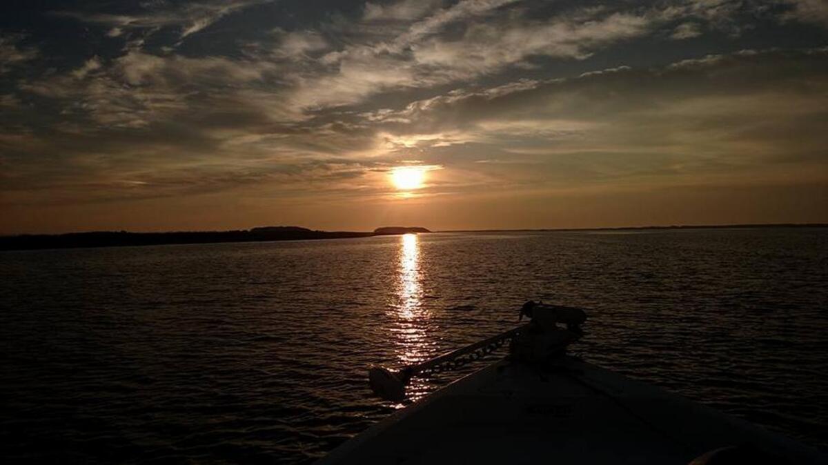 The sun rises over Winyah Bay Sunday morning at the start of a trout fishing trip.
