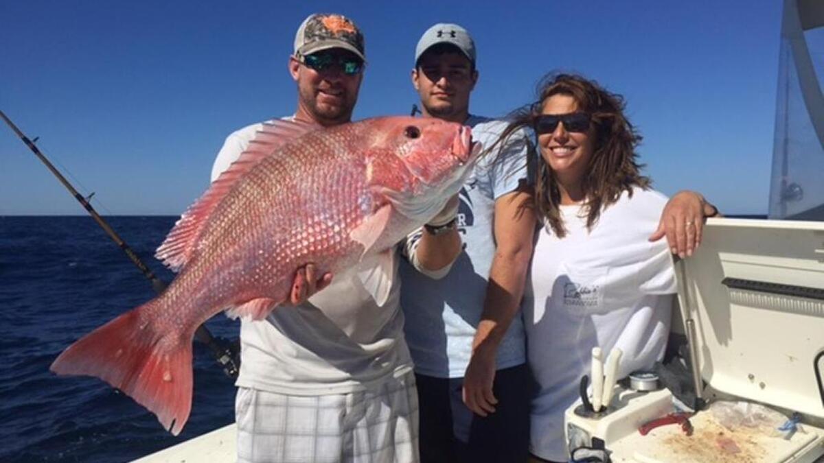 Capt. Jay Sconyers, Grant Stadler and Amy Armstrong Stadler show off a red snapper in the 20-pound range caught on Nov. 3.