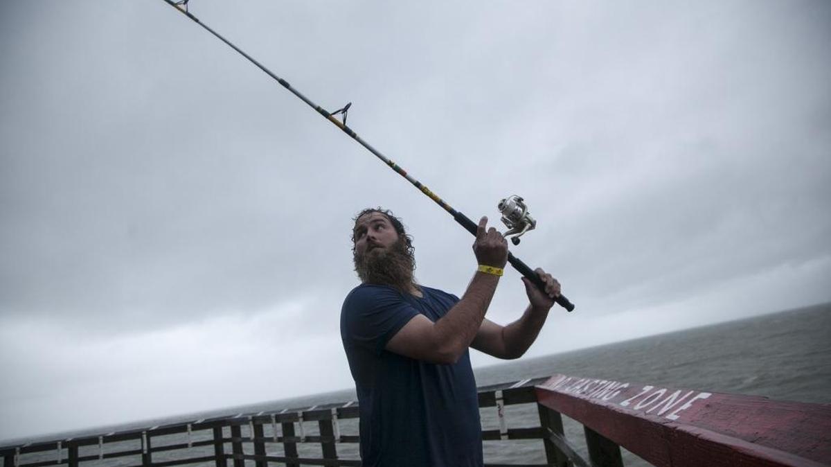 Matt Risenhoover of Cleveland, Tenn., fishes off the Cherry Grove pier despite heavy rains and winds brought on by Tropical Storm Hermine a few weeks ago.