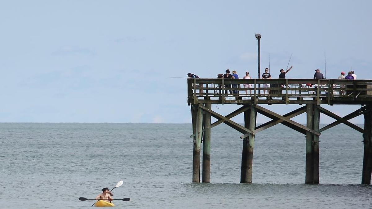 People fish and enjoy the ocean at Springmaid Beach Resort earlier this year.