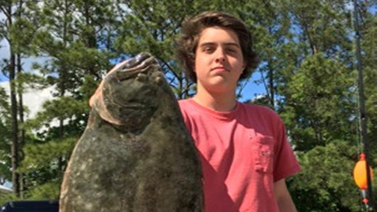 Joe Scheu, a senior at Carolina Forest High School, shows off his 4.45-pound flounder that won the Grand Strand Saltwater Anglers 15th annual Flounder Tournament last Saturday in Murrells Inlet.