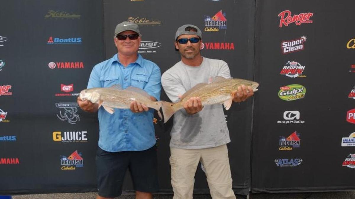 Andre DeMoux of Jacksonville, N.C., and Daniel Hill of Hampstead, N.C., show off their winning redfish which weighed an aggregate of 9.74 pounds to win an IFA Redfish Tour tournament last weekend out of the Carroll Ashemore Campbell Marine Complex in Georgetown.