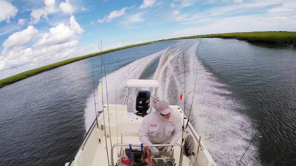 Captain Mike McDonald of Gul-R-Boy Guide Service navigates through shallow water in North Inlet on the hunt for sharks earlier this year.