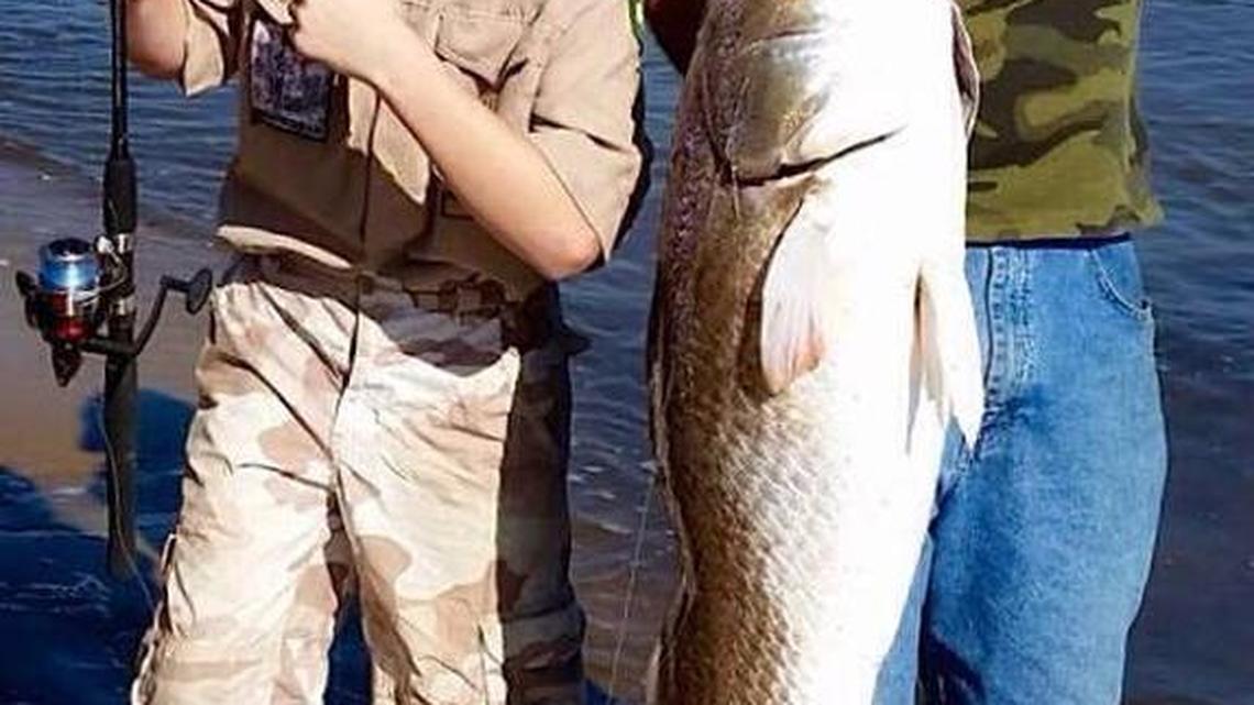 Twelve-year-old Addy Almonta and Rob Birchmeier show off a 42-inch red drum caught and released from South Island during a camping and fishing trip in November.