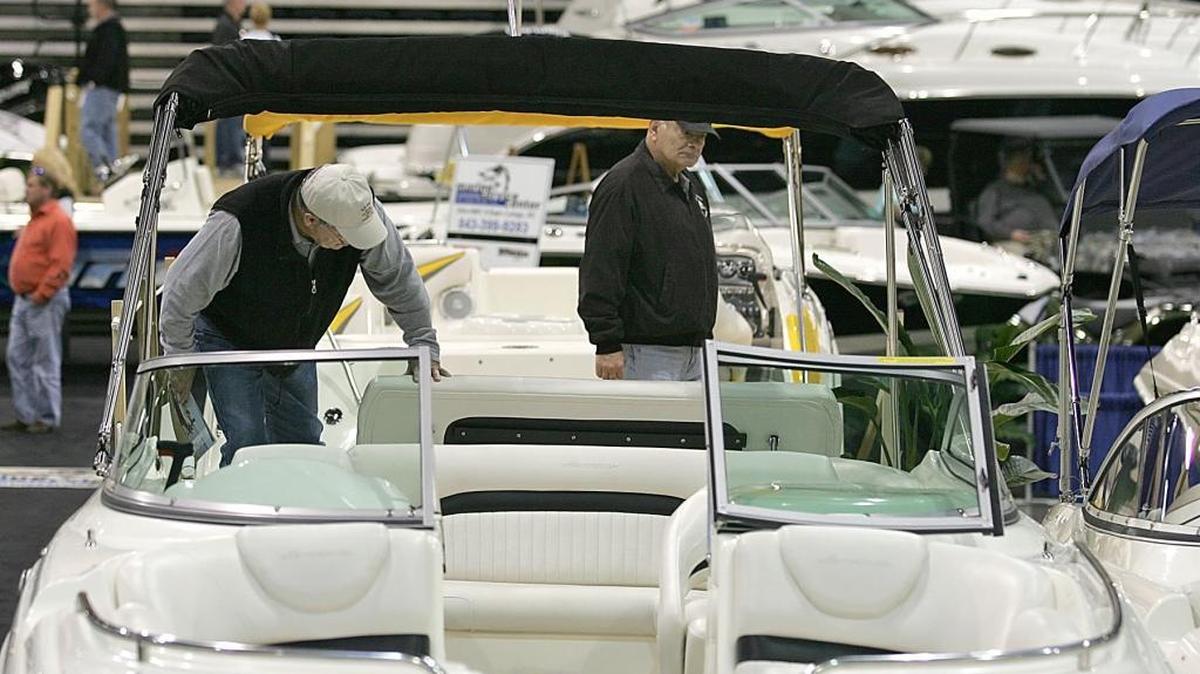 North Carolinians Steve Cosgrove (left) and Craig Jarman look over a Hurricane Sun Deck boat during the Myrtle Beach Grand Strand Boat Show.