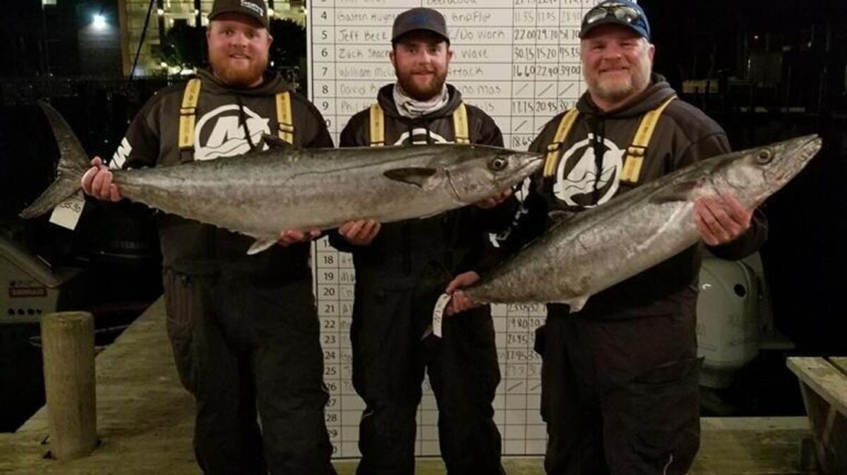 Joshua Henderson, Crockett Henderson and Mark Henderson of Liquid Fire Fishing Team display their winning king mackerel Sunday in the inaugural Kingfish Cup championship at Ocracoke, N.C.