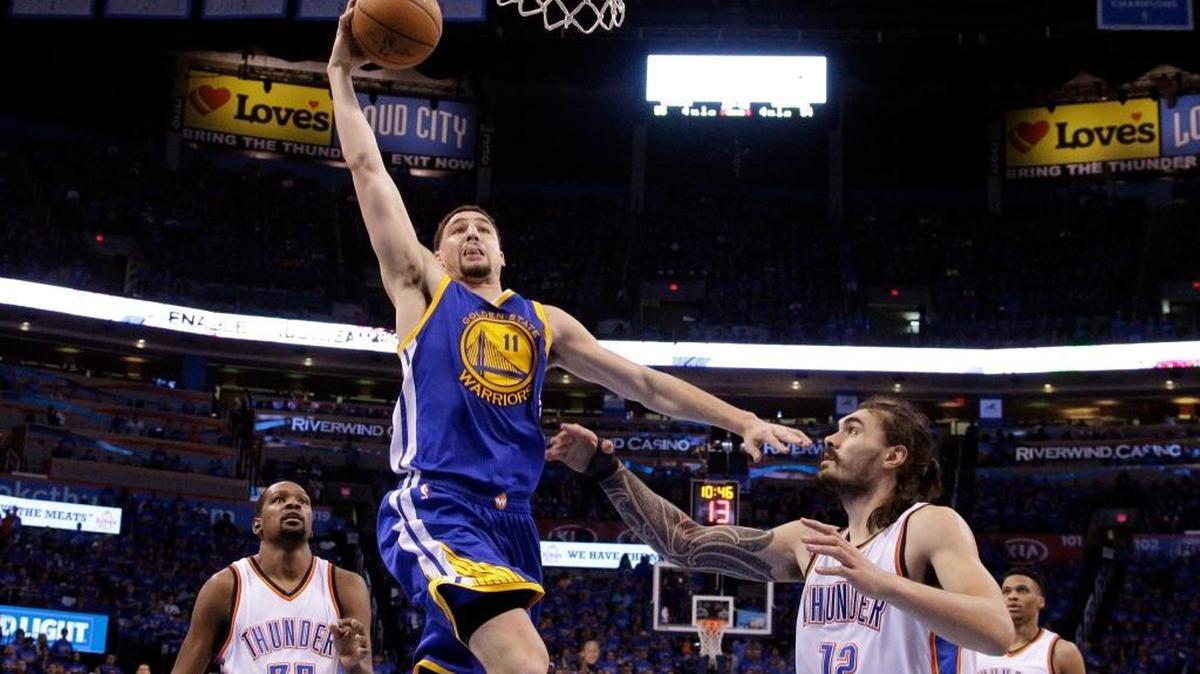 Golden State’s Klay Thompson (11) shoots over Oklahoma City’s Steven Adams (12) during Saturday’s game.