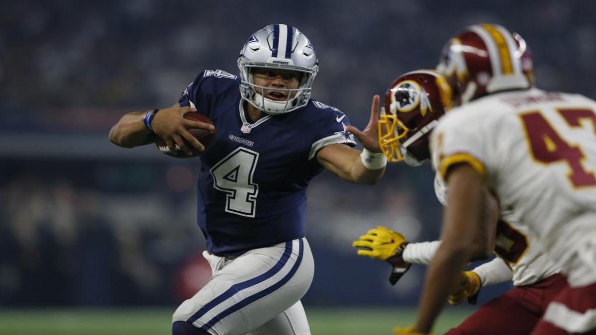 Dallas Cowboys quarterback Dak Prescott (4) fights off pressure from the Washington Redskins as he scrambles out of the pocket during last Thursday’s game.