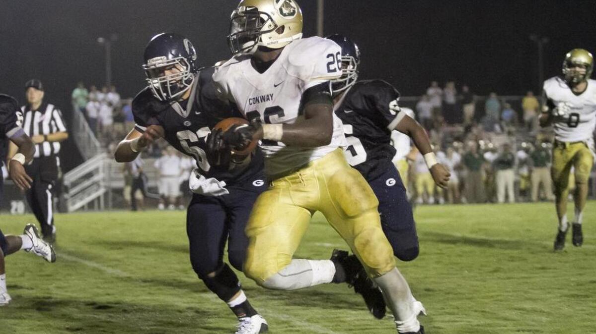 
Conway's Jerron Bellamy runs back an interception to set the Tigers up with their first touchdown against Georgetown. Conway won 22-13.
