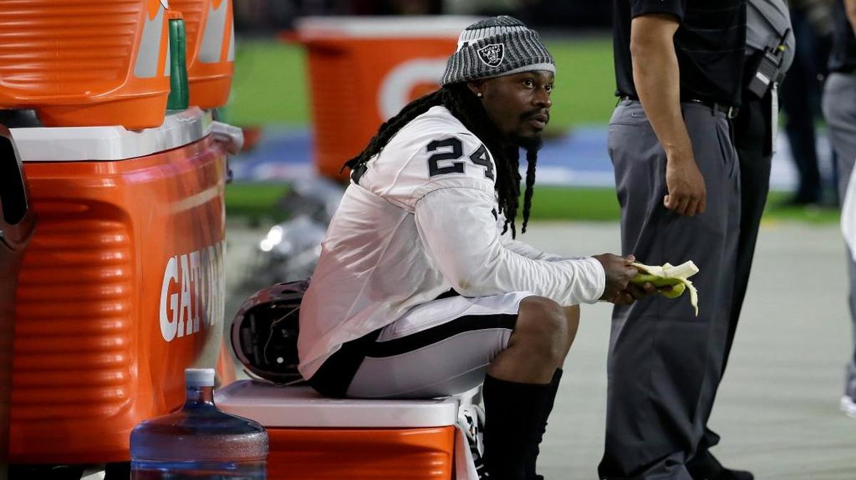 Oakland Raiders running back Marshawn Lynch (24) sits during the national anthem prior to the team’s preseason game against the Arizona Cardinals on Saturday.